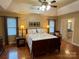 Comfortable main bedroom with tray ceilings, hardwood floors, and access to the bathroom at 121 General Pemberton St, Stanley, NC 28164