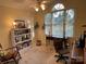 Bright office space with large window, desk and chair, complemented by a bookcase and neutral decor at 121 General Pemberton St, Stanley, NC 28164