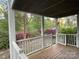 Relaxing porch view showcasing beautiful landscaping with abundant flowers and trees at 121 General Pemberton St, Stanley, NC 28164