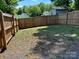 Private backyard with wood fence and grassy area, great for pets and play at 121 W 11Th St, Oakboro, NC 28129