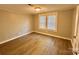 Cozy bedroom with hardwood floors and natural light from the large windows at 121 W 11Th St, Oakboro, NC 28129