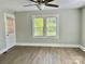 Bright bedroom with a ceiling fan and large windows overlooking the outdoors at 121 W 11Th St, Oakboro, NC 28129