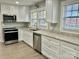 Modern kitchen with white cabinets, granite countertops, stainless steel appliances, and ample natural light at 121 W 11Th St, Oakboro, NC 28129