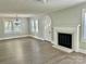 Bright living room featuring modern flooring, fireplace, and a unique arched door at 121 W 11Th St, Oakboro, NC 28129