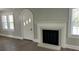 A charming living room featuring a modern fireplace, hardwood floors, and an arched doorway at 121 W 11Th St, Oakboro, NC 28129