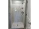 Modern shower stall with marble-style tiling, built-in shelves, and chrome fixtures at 121 W 11Th St, Oakboro, NC 28129