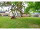 Large backyard featuring a lush lawn and mature trees surrounding the property at 1222 Glenarden Dr, Rock Hill, SC 29730