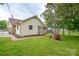 Charming backyard featuring a spacious lawn, mature trees, and a tool shed at 1222 Glenarden Dr, Rock Hill, SC 29730