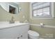 Bathroom featuring a modern sink and toilet with a window bringing in light at 1222 Glenarden Dr, Rock Hill, SC 29730