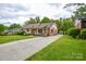 Charming home with brick and siding exterior, a long driveway, and a well-manicured lawn at 1222 Glenarden Dr, Rock Hill, SC 29730