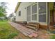 Screened-in porch with brick steps and wood-slat floor, perfect for outdoor enjoyment at 1222 Glenarden Dr, Rock Hill, SC 29730