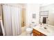 Well-lit bathroom with a shower-tub combination and a vanity with a wood finish at 123 Coachman Loop, Statesville, NC 28625