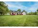 Inviting single-story home featuring a well-manicured lawn, colorful flower beds, and an attached two-car garage at 123 Coachman Loop, Statesville, NC 28625