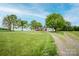 Picturesque home set on an expansive lot with mature trees and a long gravel drive, exuding country charm at 123 Coachman Loop, Statesville, NC 28625