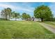 Spacious property with a charming single-story house, a large lawn, mature trees, and a long gravel driveway at 123 Coachman Loop, Statesville, NC 28625