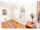 Bright foyer features hardwood floors, a decorative rug, and a window with plantation shutters at 123 Coachman Loop, Statesville, NC 28625