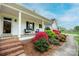 Welcoming front porch with comfortable seating and vibrant landscaping providing an inviting entrance to the home at 123 Coachman Loop, Statesville, NC 28625