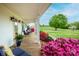 Charming front porch with comfortable seating and vibrant azaleas, creating a welcoming entrance at 123 Coachman Loop, Statesville, NC 28625