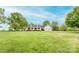 Expansive front yard leading to a charming white home featuring an inviting porch and attached two-car garage at 123 Coachman Loop, Statesville, NC 28625