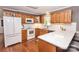 Bright kitchen with white countertops, stainless appliances and wood cabinets at 123 Coachman Loop, Statesville, NC 28625