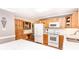 Well-lit kitchen features wood cabinets, white appliances and adjacent desk area at 123 Coachman Loop, Statesville, NC 28625