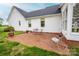 Charming brick patio with outdoor seating, perfect for relaxing by the white exterior of the house at 123 Coachman Loop, Statesville, NC 28625