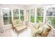 Inviting sunroom bathed in natural light featuring comfortable seating and scenic outdoor views at 123 Coachman Loop, Statesville, NC 28625