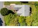 Aerial view of a home highlighting its roof, landscaping, and surrounding greenery at 12435 Mallard Dr, Charlotte, NC 28269