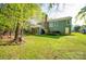 Expansive backyard with a well-maintained lawn and a glimpse of the home's exterior at 12435 Mallard Dr, Charlotte, NC 28269