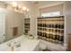 Well-lit bathroom with a vanity, a large mirror, and a shower-tub combo with a stylish curtain at 12435 Mallard Dr, Charlotte, NC 28269