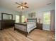 Inviting bedroom with wood-look floors, a ceiling fan, and lots of natural light from the multiple windows at 12435 Mallard Dr, Charlotte, NC 28269