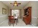 Traditional dining room with wood table and chairs, accented by a vintage china cabinet and natural light from the large window at 12435 Mallard Dr, Charlotte, NC 28269