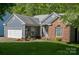 Charming one-story home with blue siding, brick accents, and a well-maintained front lawn at 12435 Mallard Dr, Charlotte, NC 28269