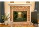 Close up of brick fireplace with mantle in the living room at 12435 Mallard Dr, Charlotte, NC 28269