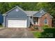 Charming single-story home with blue siding, brick accents, and a well-manicured front yard at 12435 Mallard Dr, Charlotte, NC 28269