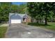 Charming single-Gathering home with blue siding, brick accents, and a well-maintained front yard at 12435 Mallard Dr, Charlotte, NC 28269