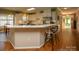Bright kitchen features white cabinets, stainless steel appliances and breakfast bar seating at 12435 Mallard Dr, Charlotte, NC 28269