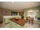 Open kitchen layout with kitchen island, eat-in area, and views of the living room at 12435 Mallard Dr, Charlotte, NC 28269