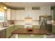Bright kitchen with stainless steel appliances, white cabinets, and a central island at 12435 Mallard Dr, Charlotte, NC 28269