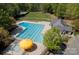 Aerial view of a large community pool with lap lanes, a kiddie pool, and a yellow umbrella at 12435 Mallard Dr, Charlotte, NC 28269