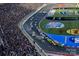 Aerial view of the Charlotte Motor Speedway, filled with race cars and excited spectators at 12435 Mallard Dr, Charlotte, NC 28269