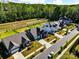 An aerial view showcases a community with well-manicured lawns and landscaping backing to preserved green space at 12512 Journeys End Trl, Huntersville, NC 28078
