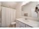 Clean bathroom featuring white cabinets, light countertops, and a shower with a patterned curtain at 12512 Journeys End Trl, Huntersville, NC 28078