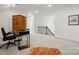 Bonus room or flex space with desk, wooden cabinet, neutral carpet and railing at 12512 Journeys End Trl, Huntersville, NC 28078