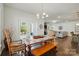 Open floor plan features a dining area with a wooden table, bench seating, and views into the living room at 12512 Journeys End Trl, Huntersville, NC 28078