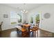 Bright dining area features hardwood floors, stylish lighting, and views of the backyard through large windows at 12512 Journeys End Trl, Huntersville, NC 28078