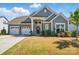 Beautiful home showcasing a three-car garage, stone accents, and a welcoming front entrance at 12512 Journeys End Trl, Huntersville, NC 28078