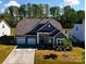 Charming home boasts a three-car garage, well-manicured lawn, and inviting curb appeal at 12512 Journeys End Trl, Huntersville, NC 28078