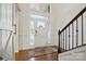 Bright foyer with hardwood floors, wainscoting and a staircase with wooden railing at 12512 Journeys End Trl, Huntersville, NC 28078