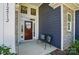 Inviting front porch with a charming entrance, stone pillars, and cozy seating area at 12512 Journeys End Trl, Huntersville, NC 28078